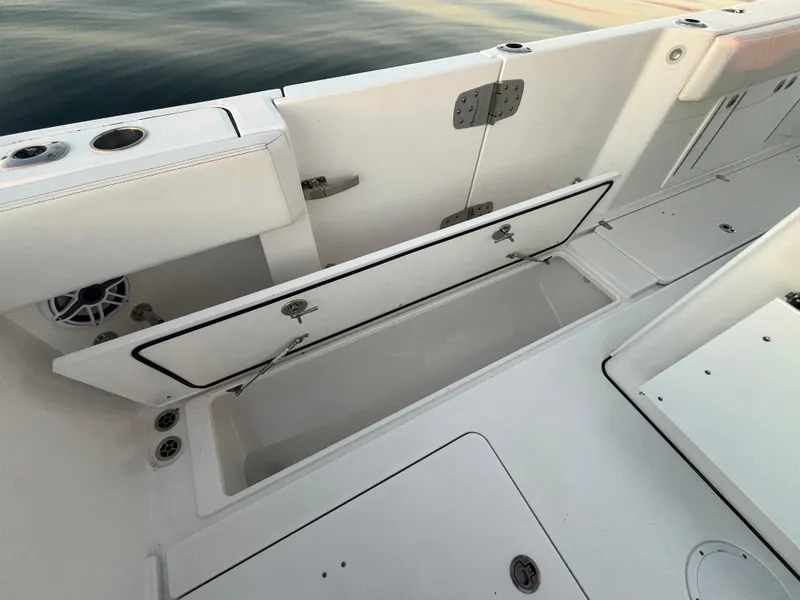 Slide: The Image of Edgewater 340CC 2022 boat storage compartment open on deck. - 29