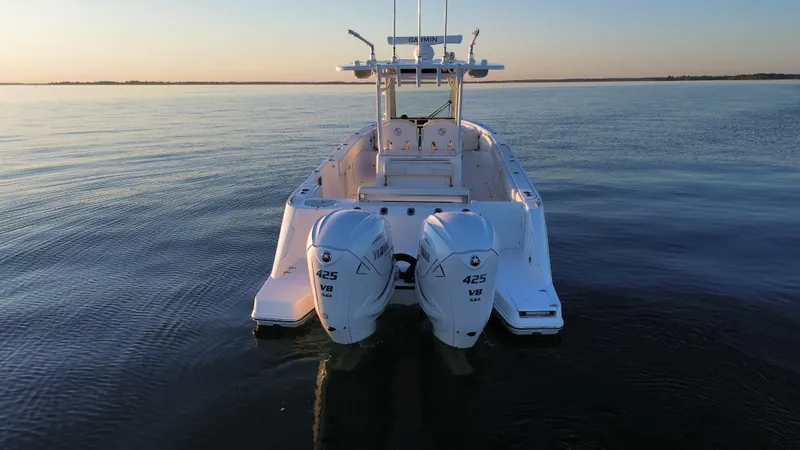 Slide: The Image of Edgewater 340CC 2022 boat with twin 425 HP engines on calm water. - 3