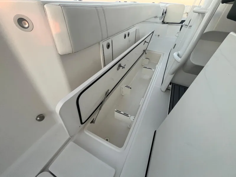 Slide: The Image of 2022 Edgewater 340CC boat interior with open storage compartments. - 31
