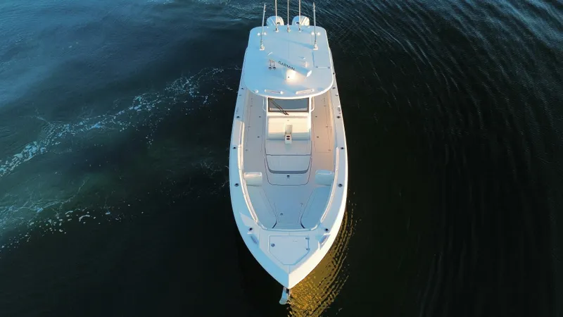 Slide: The Image of Aerial view of 2022 Edgewater 340CC boat cruising on calm water. - 7