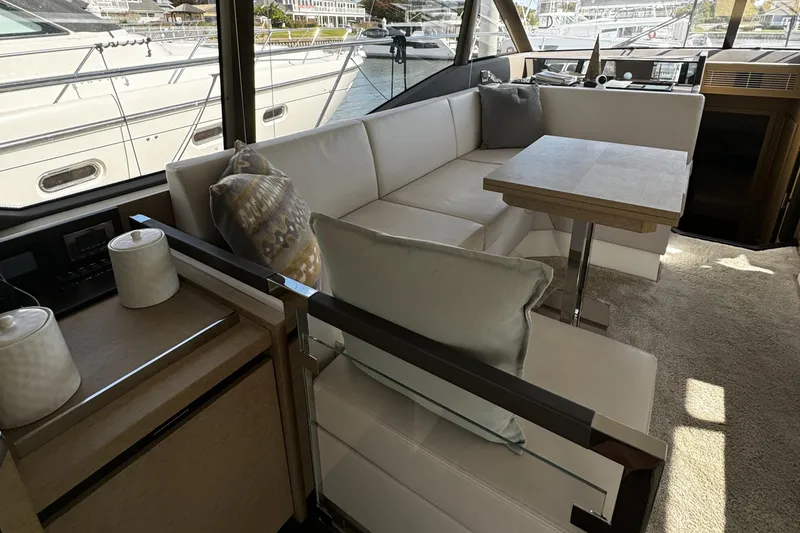 Slide: The Image of Luxurious interior of 2019 Prestige 460 Fly Bridge yacht with elegant seating and table. - 11