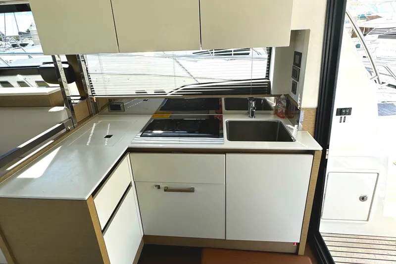 Slide: The Image of Modern kitchen on 2019 Prestige 460 Fly Bridge yacht with sleek design and appliances. - 15