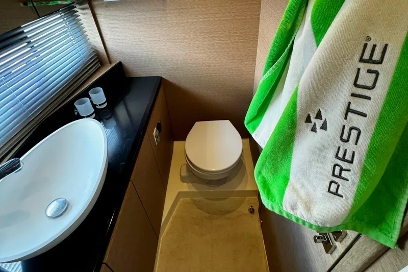 Slide: The Image of Luxury bathroom in 2019 Prestige 460 Fly Bridge yacht with modern sink and branded towel. - 30