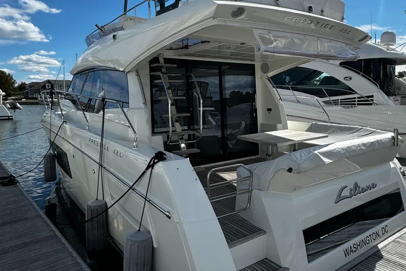Slide: The Image of 2019 Prestige 460 Fly Bridge yacht docked, featuring sleek design and spacious deck. - 4