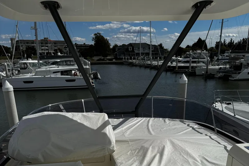 Slide: The Image of Prestige 460 Fly Bridge 2019 yacht docked in a marina with other boats. - 40