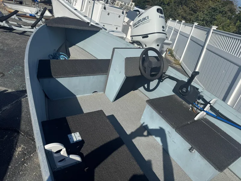 Slide: The Image of 2016 Starcraft SF 14 boat interior with steering wheel and Suzuki outboard motor. - 3