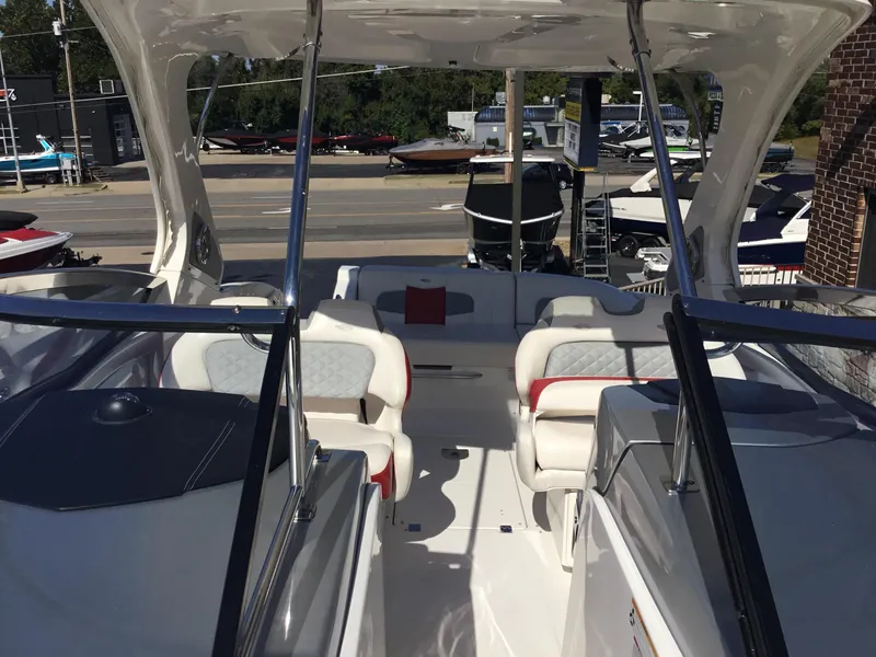 Slide: The Image of 2012 Chaparral 327 SSX boat interior with white seating and sleek design. - 10