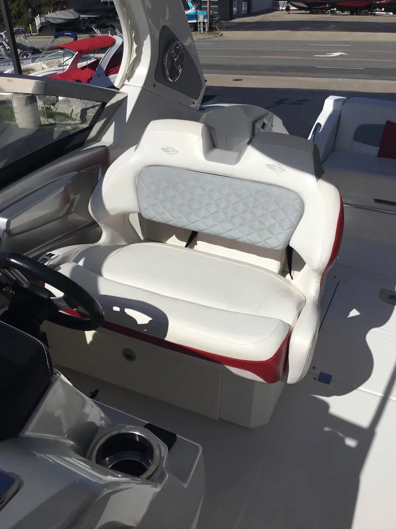 Slide: The Image of 2012 Chaparral 327 SSX boat interior with white and red seating. - 11