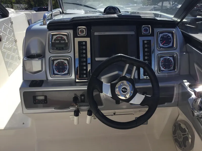Slide: The Image of 2012 Chaparral 327 SSX boat dashboard with steering wheel and gauges. - 13
