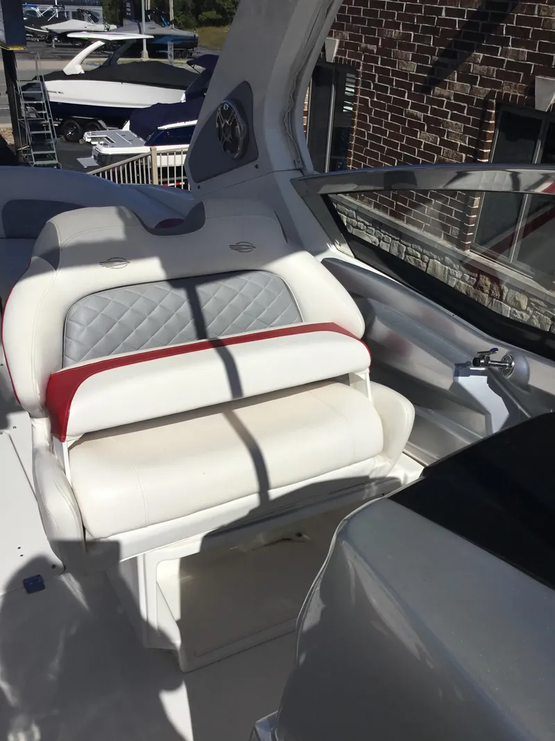 Slide: The Image of 2012 Chaparral 327 SSX boat interior with white and red seating. - 14