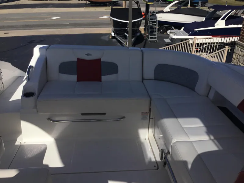 Slide: The Image of 2012 Chaparral 327 SSX boat interior with white seating and red accent pillow. - 18