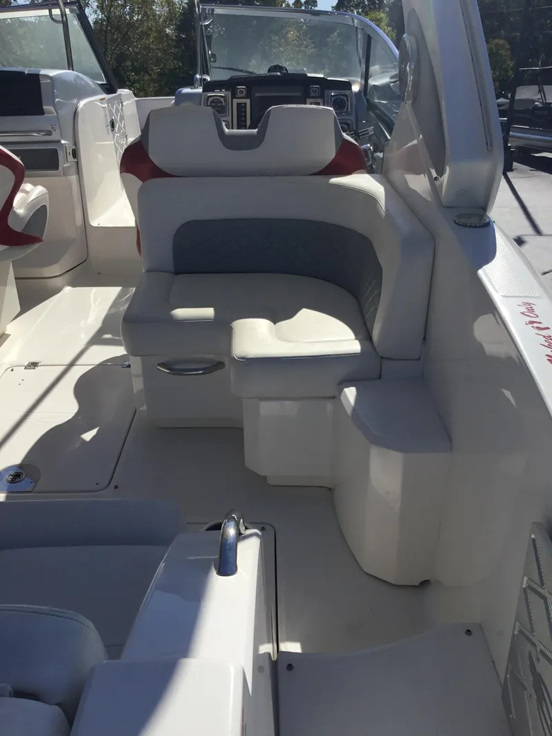 Slide: The Image of 2012 Chaparral 327 SSX boat interior with white seating and helm. - 19