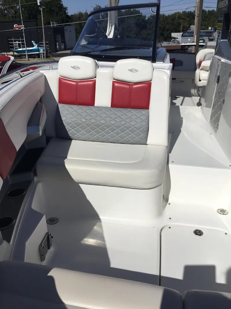 Slide: The Image of 2012 Chaparral 327 SSX boat interior with red and white seating. - 7