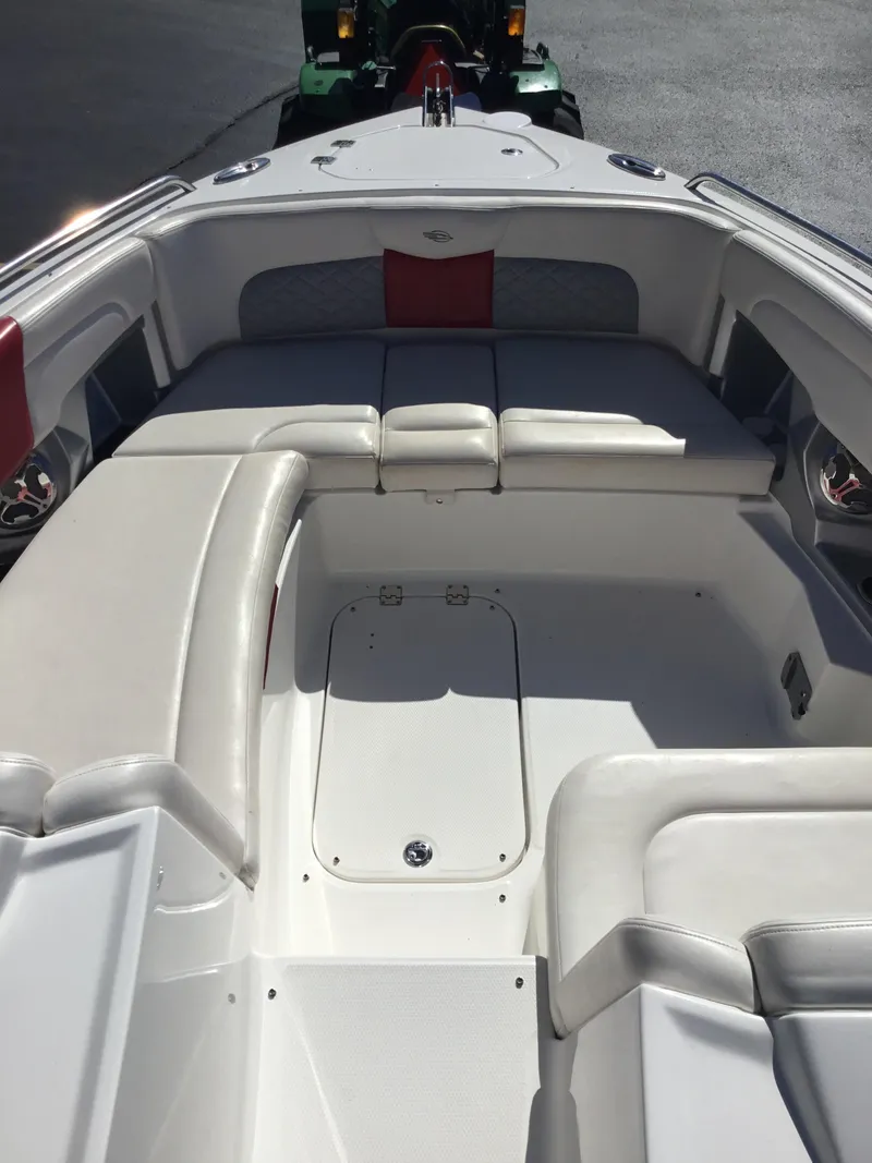 Slide: The Image of 2012 Chaparral 327 SSX boat interior with white seating and red accents. - 8