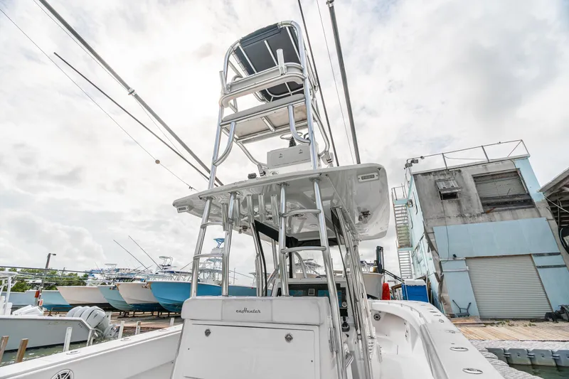 Slide: The Image of 2017 SeaHunter 39 Tournament boat with tower, docked at marina under cloudy sky. - 10