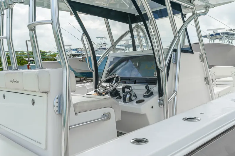 Slide: The Image of 2017 SeaHunter 39 Tournament boat interior with steering console and seating. - 2