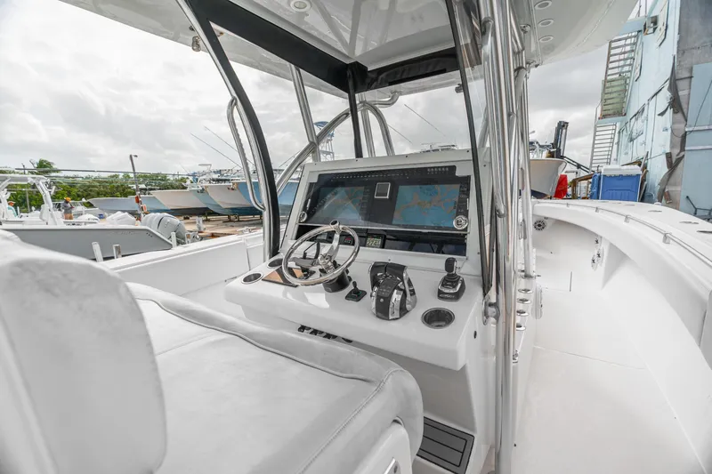 Slide: The Image of 2017 SeaHunter 39 Tournament boat cockpit with steering wheel and navigation system. - 5