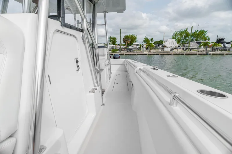 Slide: The Image of 2017 SeaHunter 39 Tournament boat deck with sleek design, docked by the water. - 8