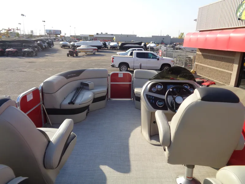 Slide: The Image of 2022 South Bay 222RS pontoon boat interior with beige seating and modern dashboard. - 10
