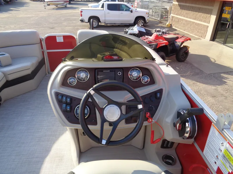 Slide: The Image of 2022 South Bay 222RS boat dashboard with steering wheel and controls. - 11