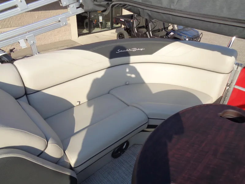 Slide: The Image of 2022 South Bay 222RS boat interior with plush seating and table. - 14