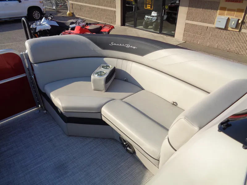 Slide: The Image of 2022 South Bay 222RS boat with beige seating and cup holders. - 16