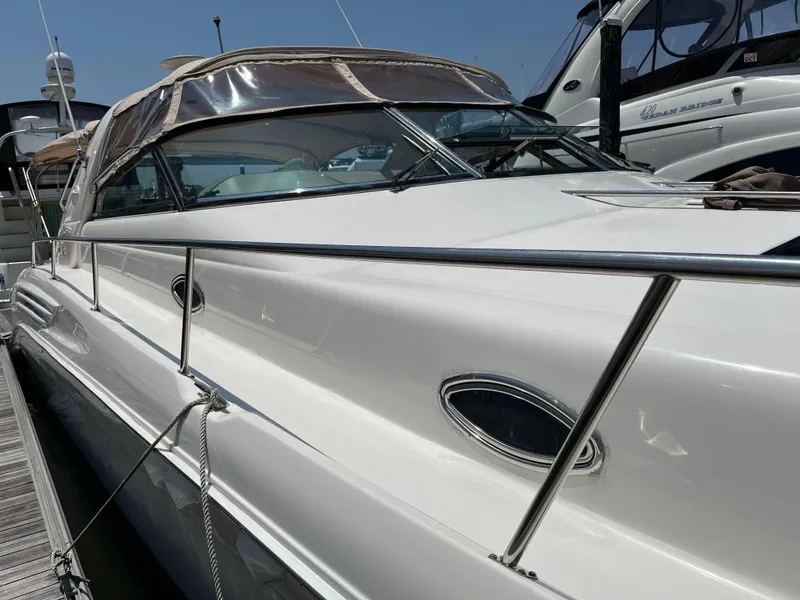 Slide: The Image of 1998 Sea Ray 450 Sundancer yacht docked at marina, side view. - 10