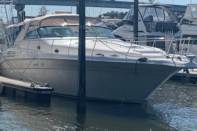 Slide: The Image of 1998 Sea Ray 450 Sundancer yacht docked at marina, side view. - 12