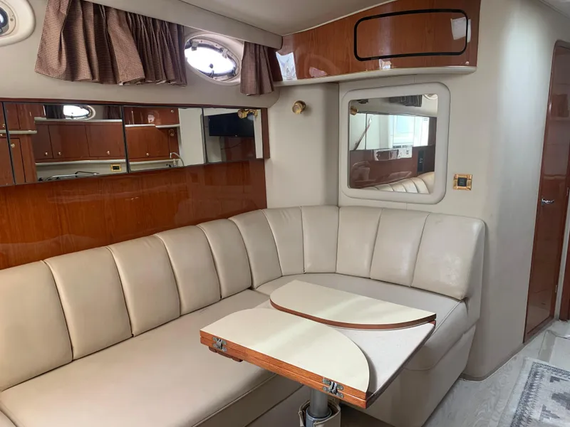 Slide: The Image of Interior of 1998 Sea Ray 450 Sundancer with beige seating and wooden accents. - 18