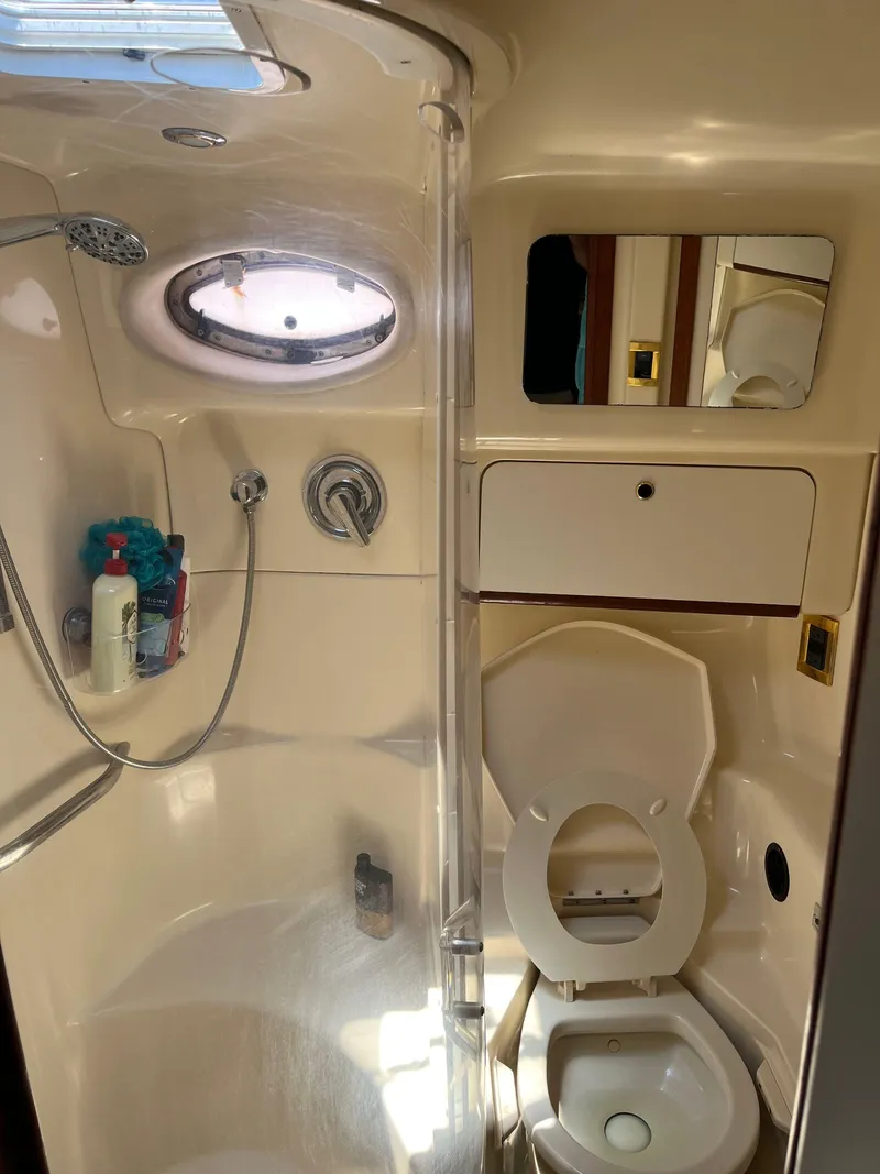 Slide: The Image of 1998 Sea Ray 450 Sundancer bathroom with shower and toilet. - 24