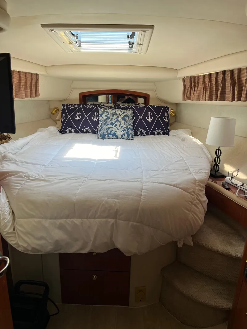 Slide: The Image of Cozy bedroom in 1998 Sea Ray 450 Sundancer yacht with skylight and nautical decor. - 27
