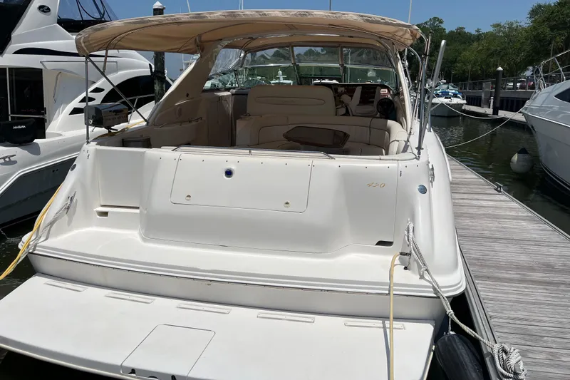Slide: The Image of 1998 Sea Ray 450 Sundancer yacht docked at marina, rear view. - 32