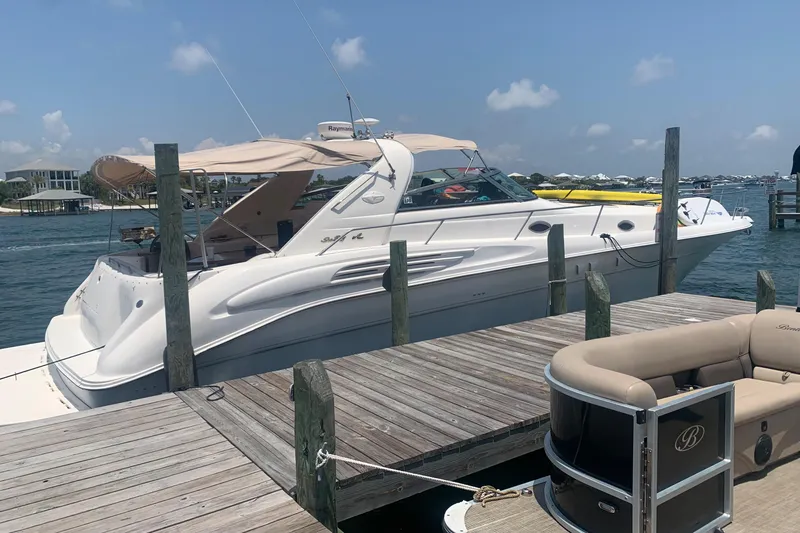 Slide: The Image of 1998 Sea Ray 450 Sundancer yacht docked at a marina on a sunny day. - 34