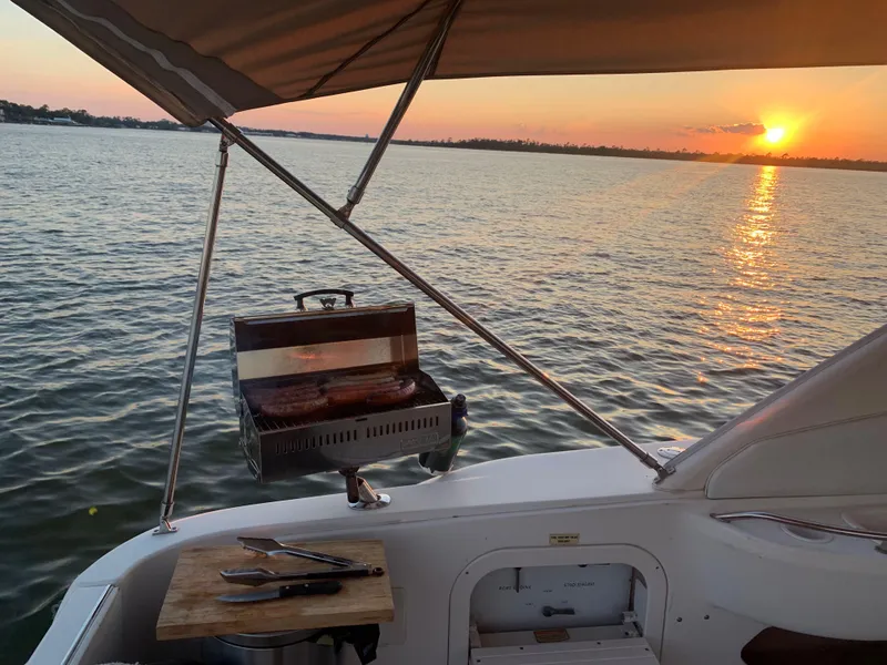 Slide: The Image of Sea Ray 450 Sundancer 1998 yacht with sunset view and onboard grill. - 4