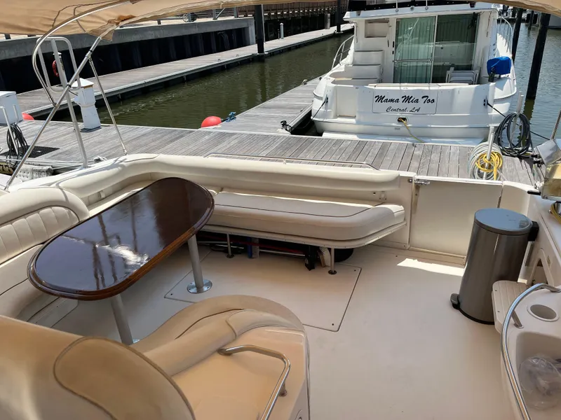 Slide: The Image of 1998 Sea Ray 450 Sundancer yacht interior with seating and table at marina dock. - 6