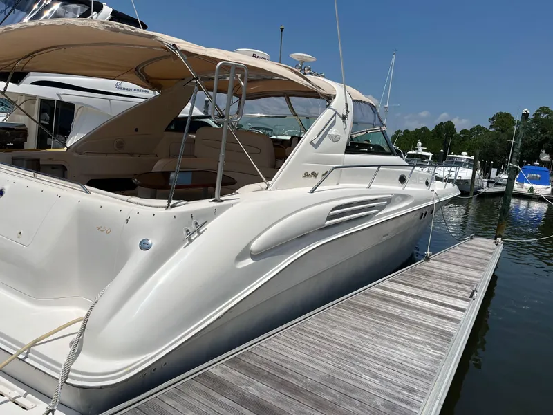 Slide: The Image of 1998 Sea Ray 450 Sundancer yacht docked at marina under clear blue sky. - 8