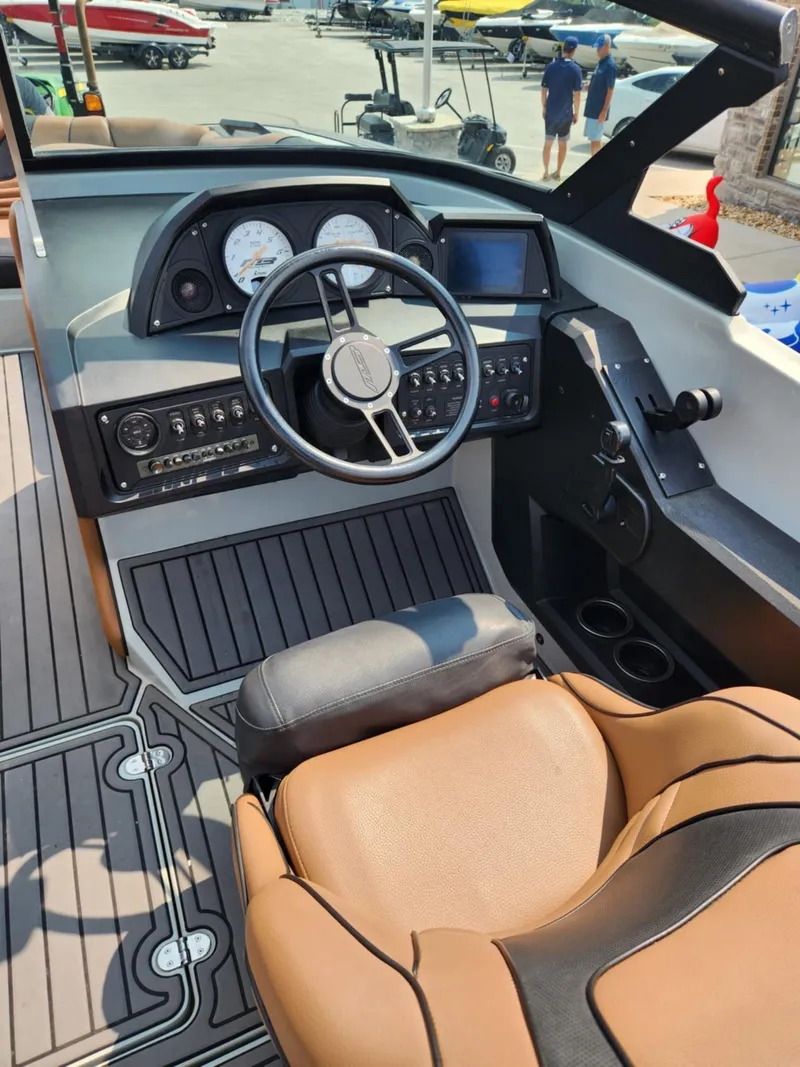 Slide: The Image of 2020 MB F24 Tomcat boat cockpit with modern controls and tan seating. - 10