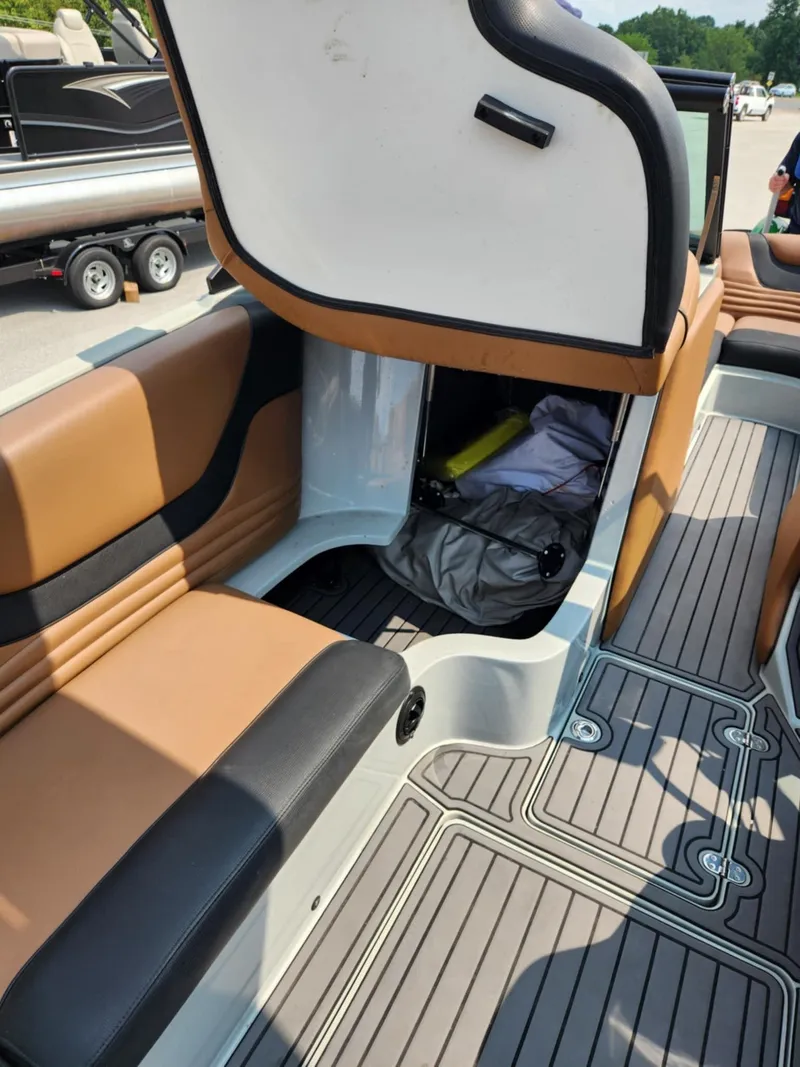 Slide: The Image of 2020 MB F24 Tomcat boat interior with storage compartment and seating. - 12