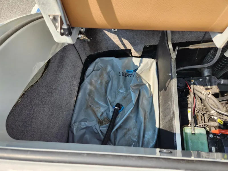 Slide: The Image of 2020 MB F24 Tomcat storage compartment with tarp and engine components. - 15