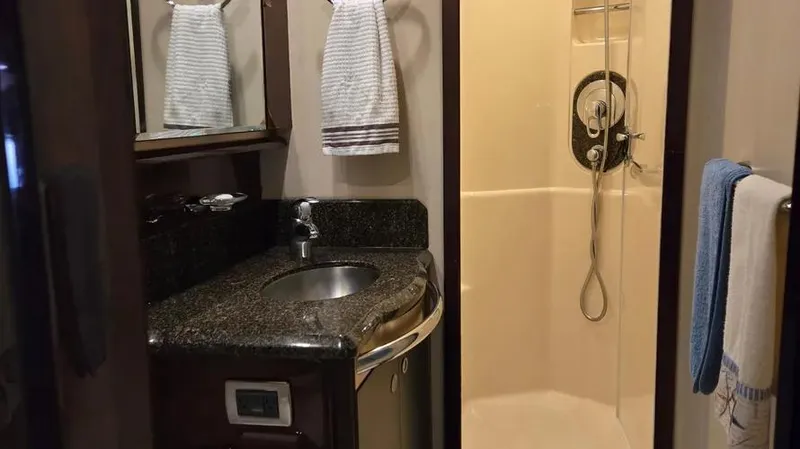 Slide: The Image of Luxurious bathroom in 2007 Sea Ray 580 Sedan Bridge yacht with granite countertop and shower. - 10