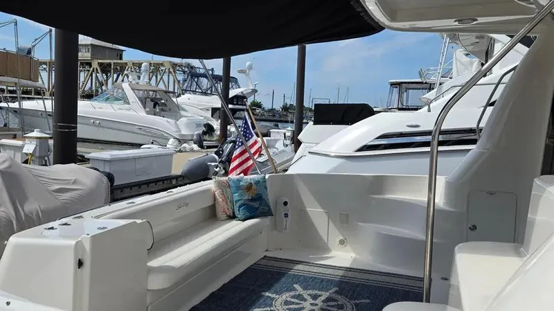 Slide: The Image of 2007 Sea Ray 580 Sedan Bridge yacht interior with seating and American flag. - 14