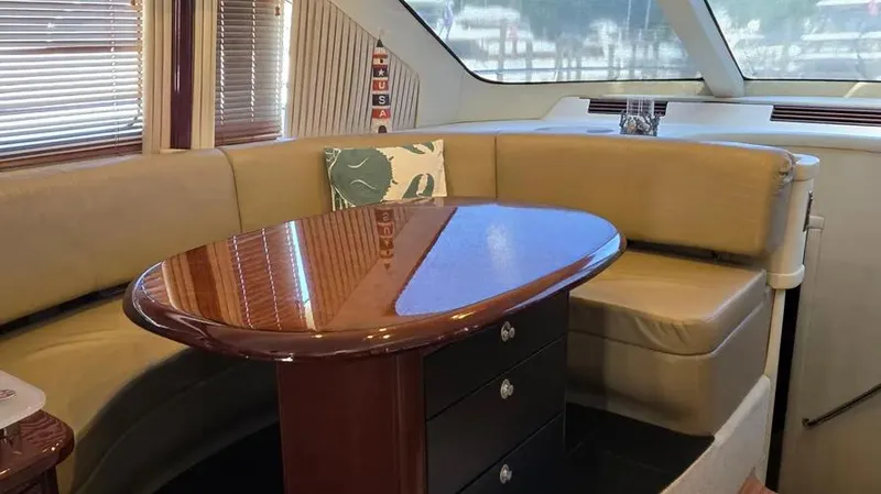 Slide: The Image of Luxurious 2007 Sea Ray 580 Sedan Bridge interior with elegant seating and polished wood table. - 15