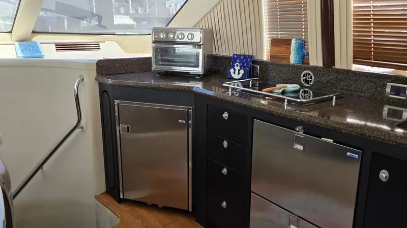 Slide: The Image of Luxurious kitchen area in 2007 Sea Ray 580 Sedan Bridge yacht. - 16