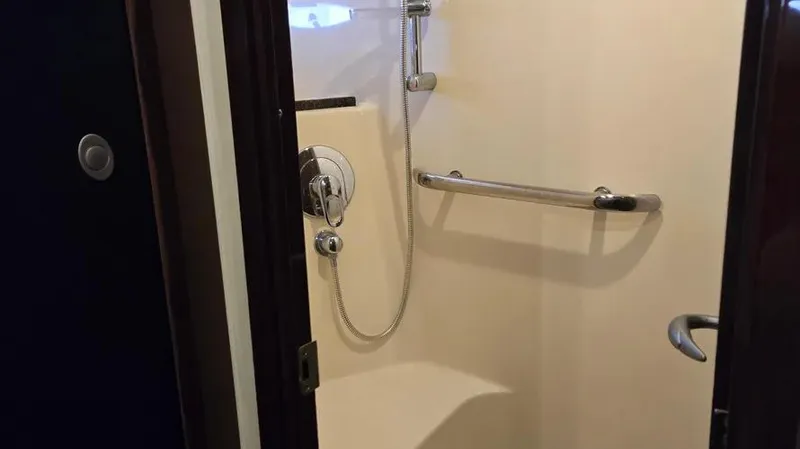 Slide: The Image of Shower area in 2007 Sea Ray 580 Sedan Bridge yacht with grab bar and handheld showerhead. - 2