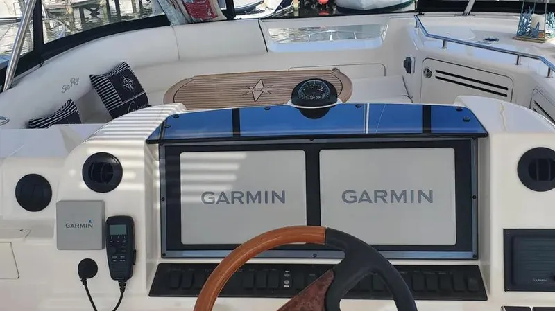 Slide: The Image of 2007 Sea Ray 580 Sedan Bridge helm with Garmin navigation displays. - 23