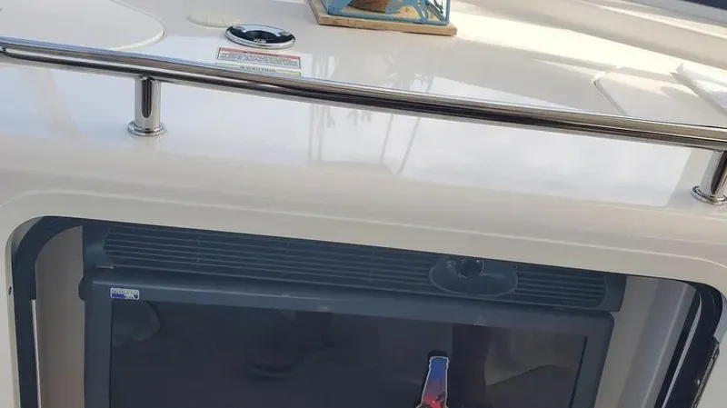 Slide: The Image of 2007 Sea Ray 580 Sedan Bridge interior detail with fridge and railing. - 5