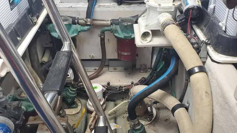 Slide: The Image of Engine room of 2007 Sea Ray 580 Sedan Bridge with visible hoses and components. - 8