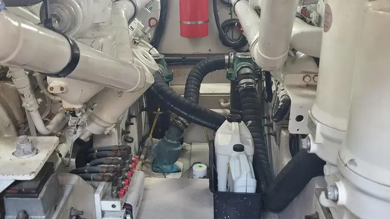 Slide: The Image of Engine room of 2007 Sea Ray 580 Sedan Bridge with visible components and fire extinguisher. - 9