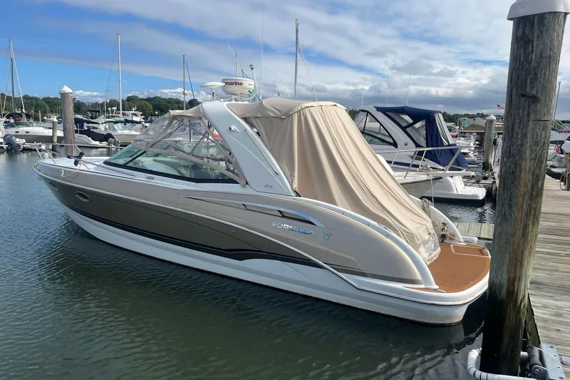 The Image of 2011 Formula 310 Sun Sport boat docked at marina, covered, with clear skies. - 0