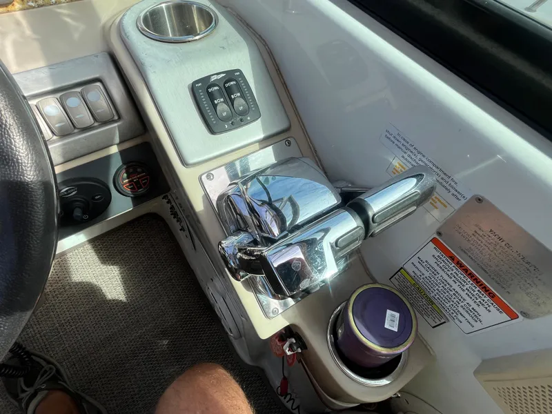 Slide: The Image of 2011 Formula 310 Sun Sport boat control panel with chrome throttle and cup holder. - 10